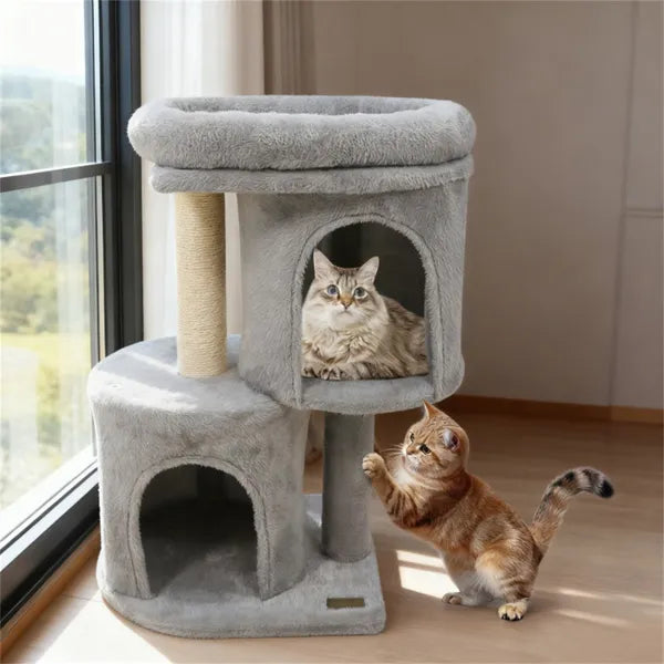 Cat tree with two cats interacting in a room with a window.