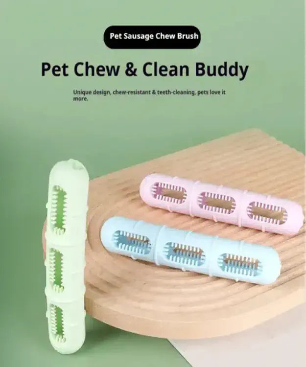 Pet chew and clean buddy brushes on a wooden surface with a green background