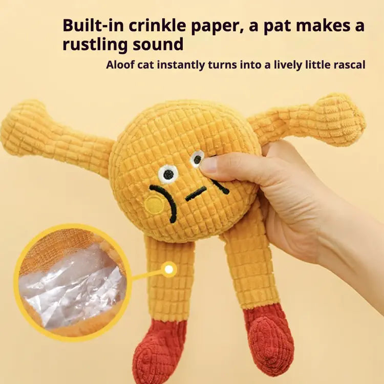 Yellow plush toy with crinkle paper inside, held by a hand on a beige background.